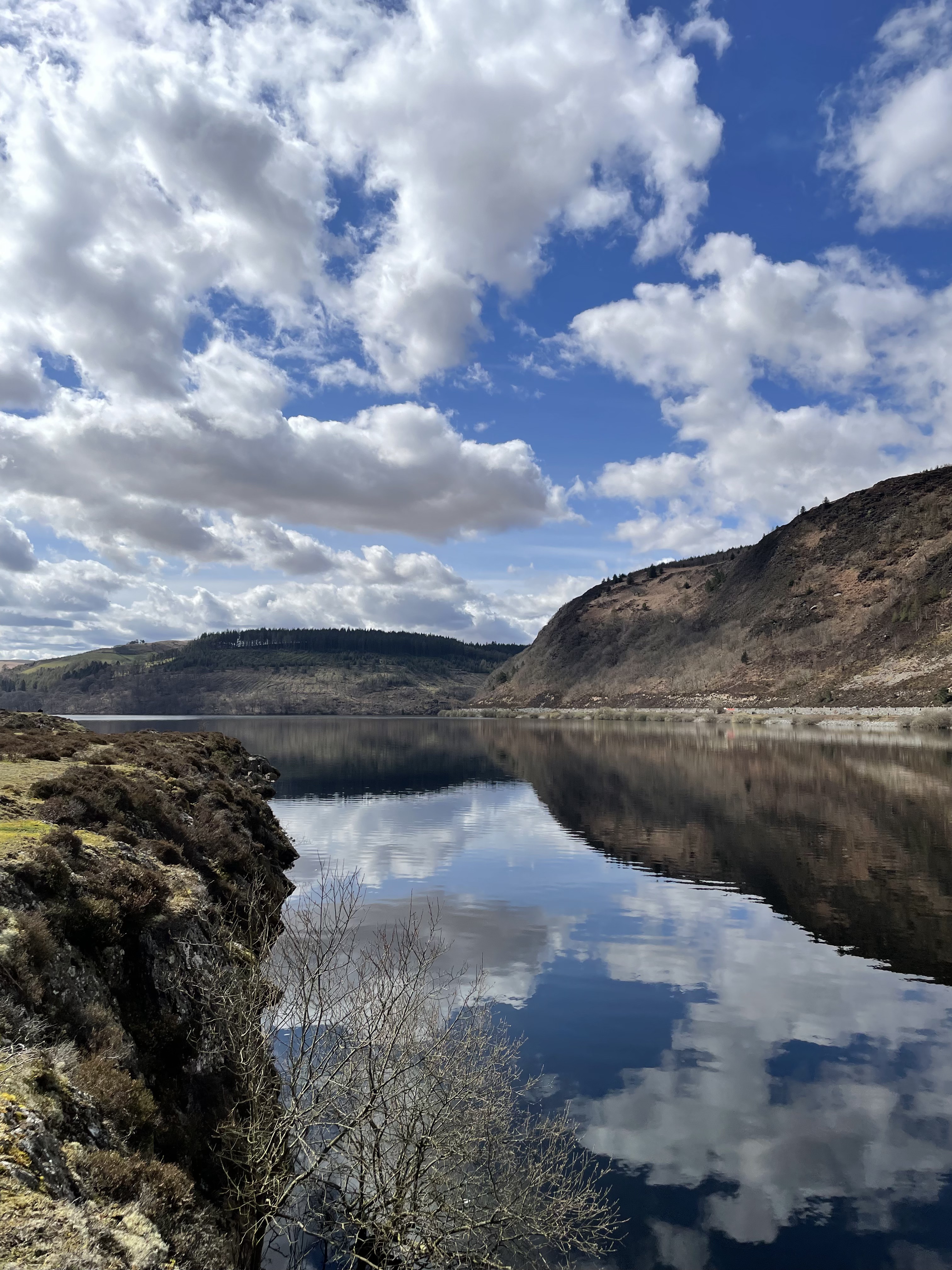 A peaceful lake reflecting the hills and sky